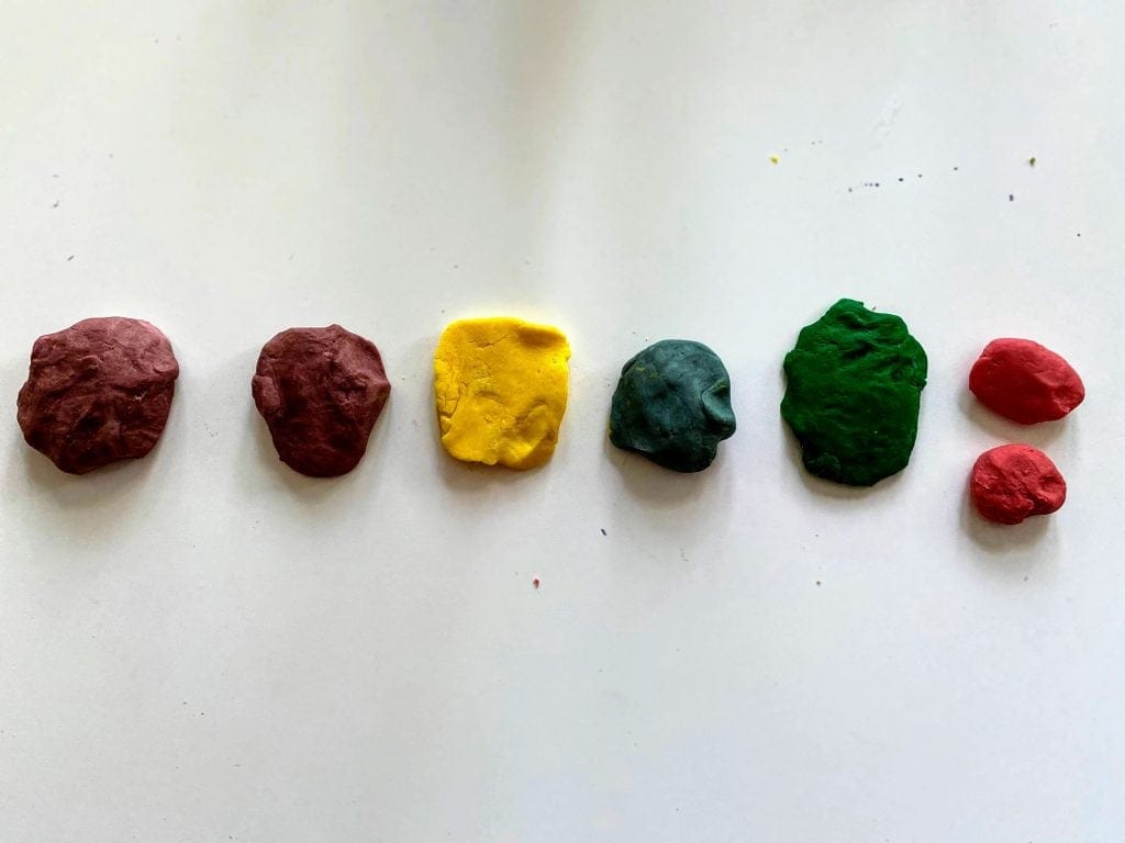 several colored balls of play dough 