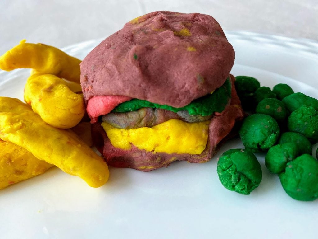 Play dough burger, fries and peas on plate