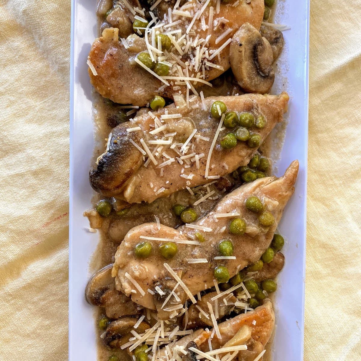 Chicken marsala topped with cheese on plate