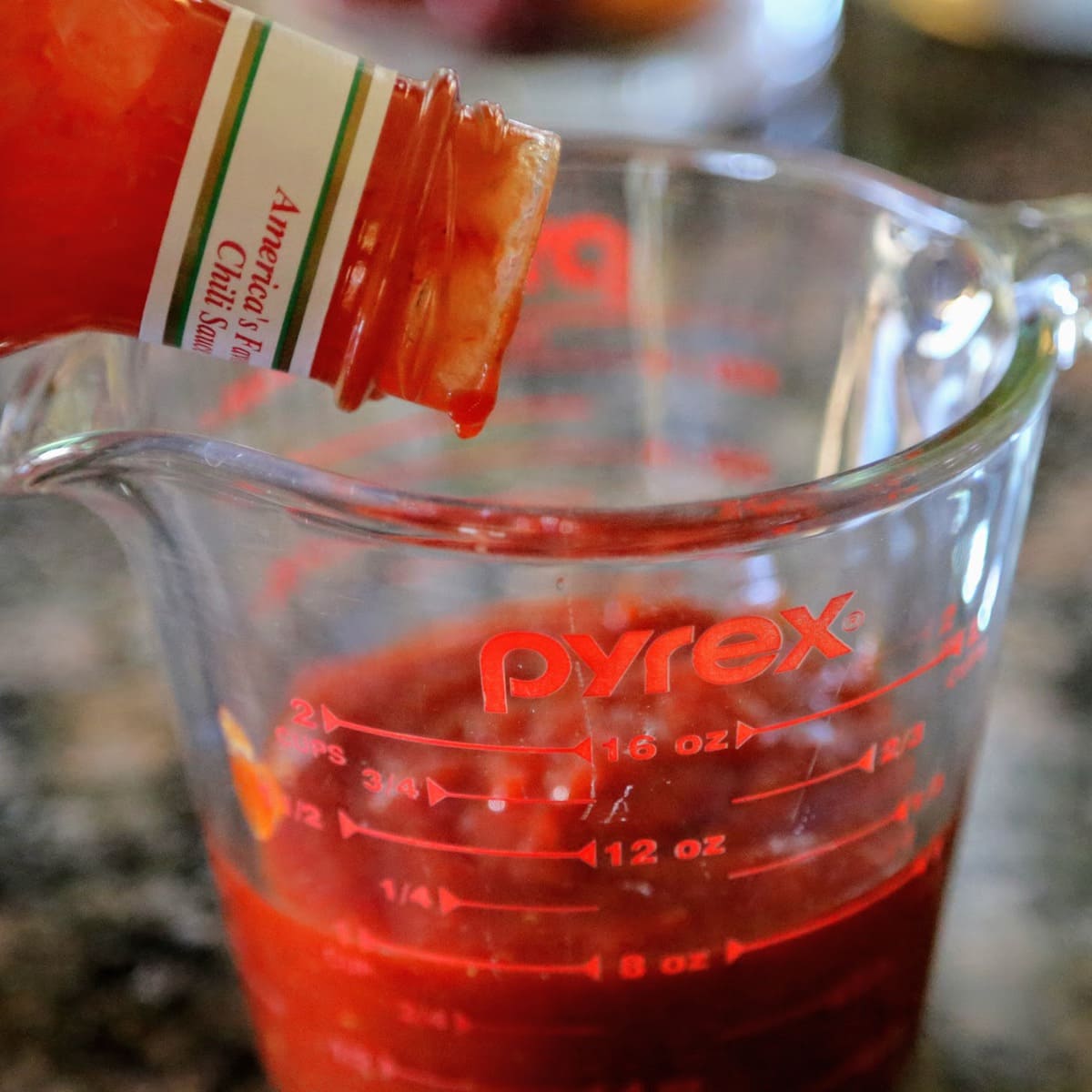 pouring chili sauce into pyrex