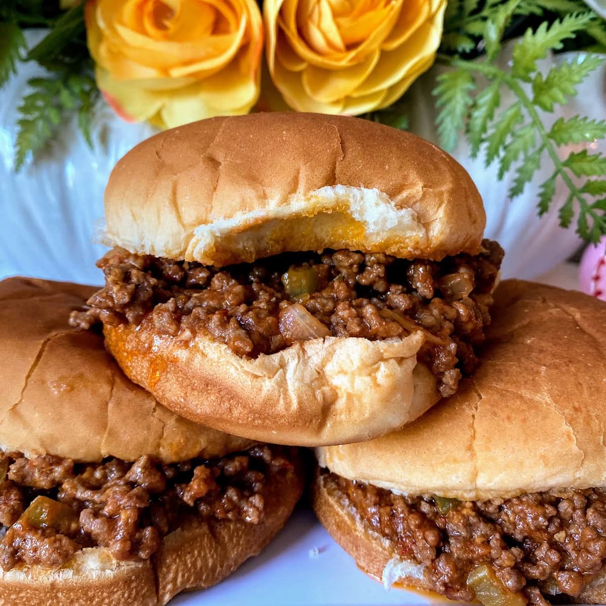 three sloppy joes stacked in buns