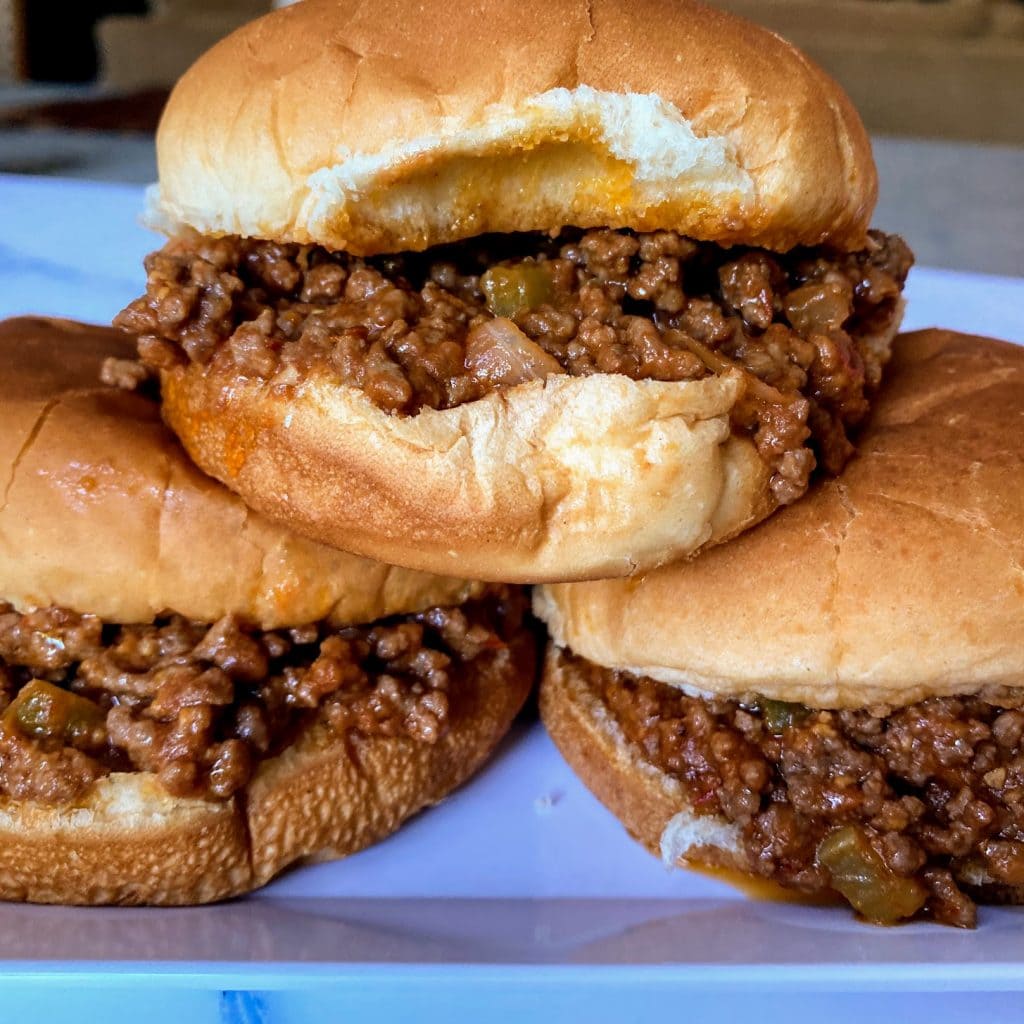 three old fashioned sloppy joes with meat spilling out
