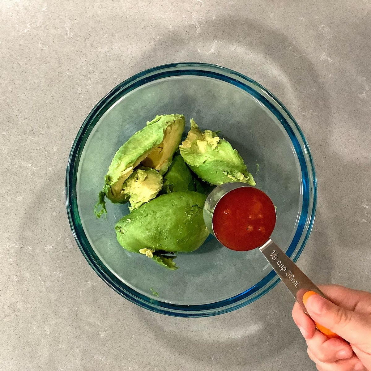 adding 1/8 cup salsa to avocado to make guacamole