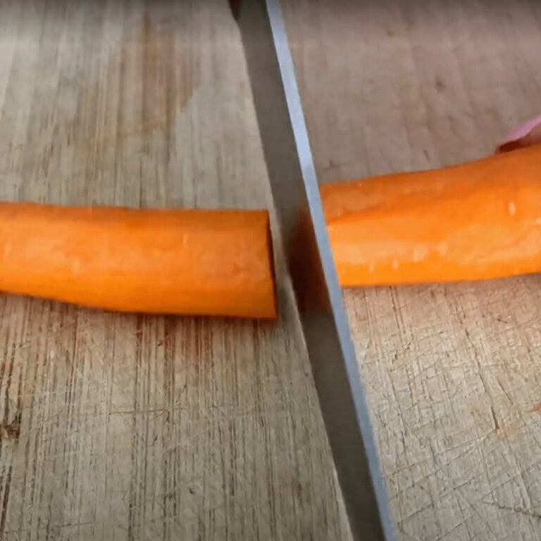 slicing whole carrot in half