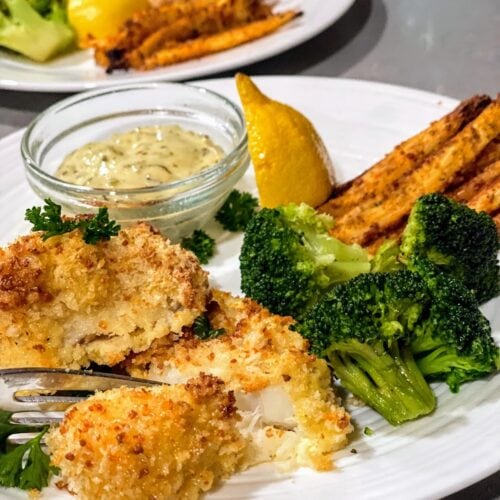 baked white fish with lemon, broccoli and fries