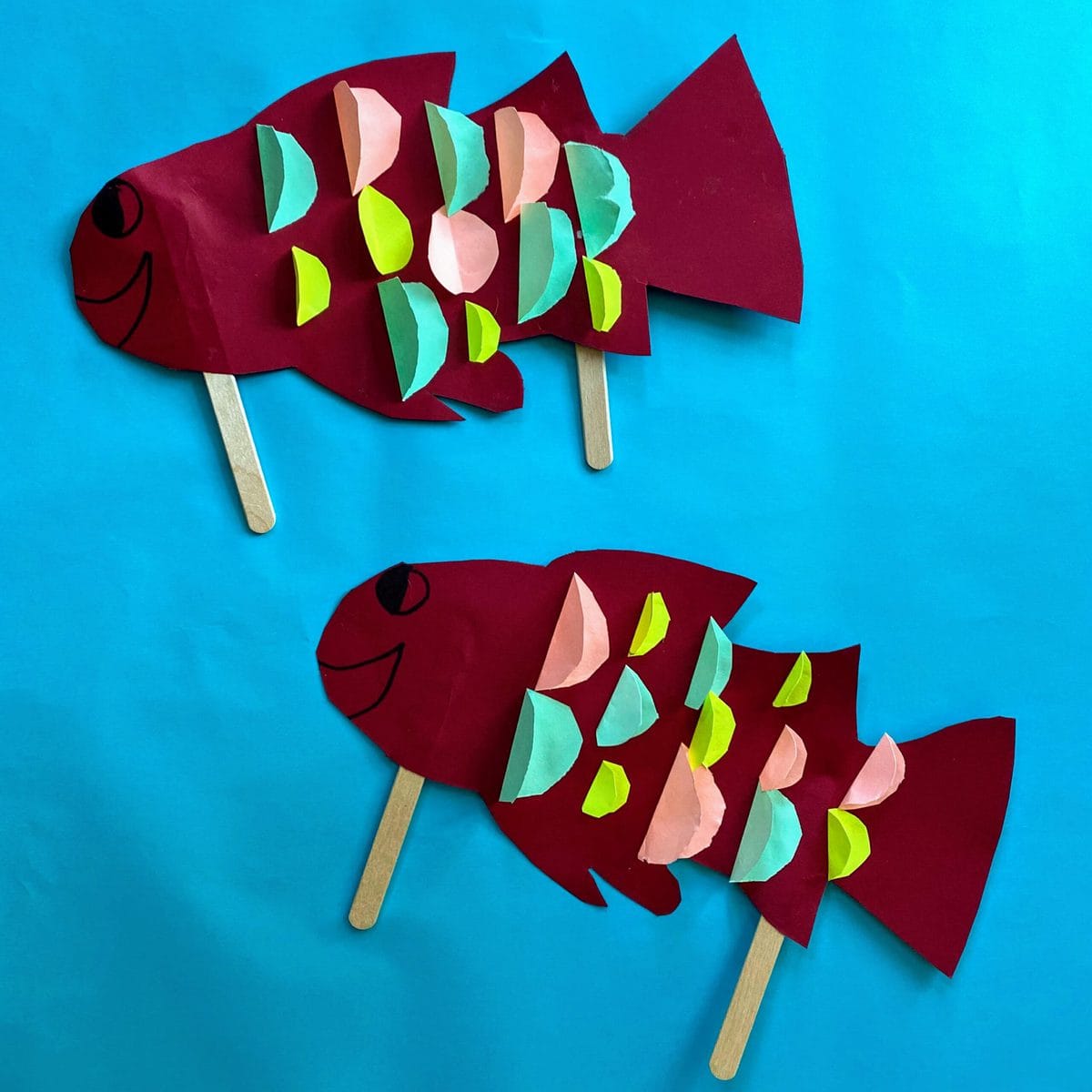 two paper fish puppets swimming