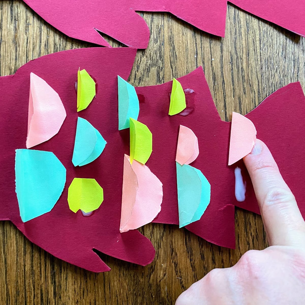 gluing folded circles onto fish to form scales 