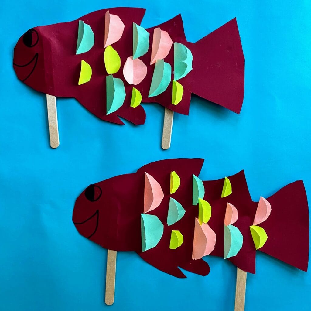 two paper fish puppets