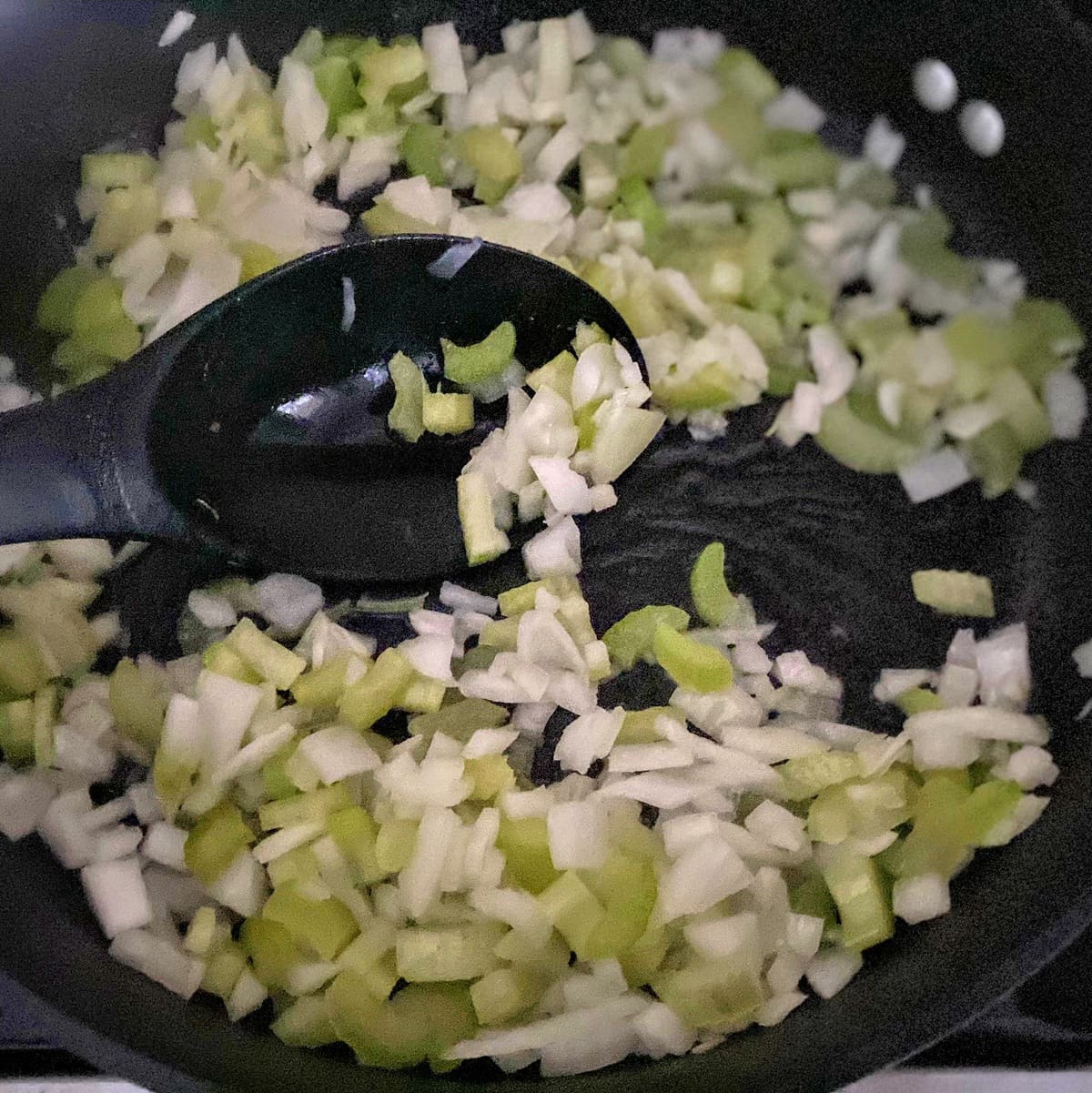 cooking onion and celery in pan