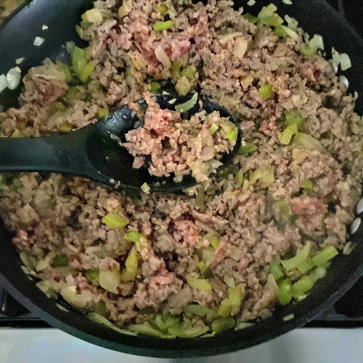 sausage and veggies cooking in pan