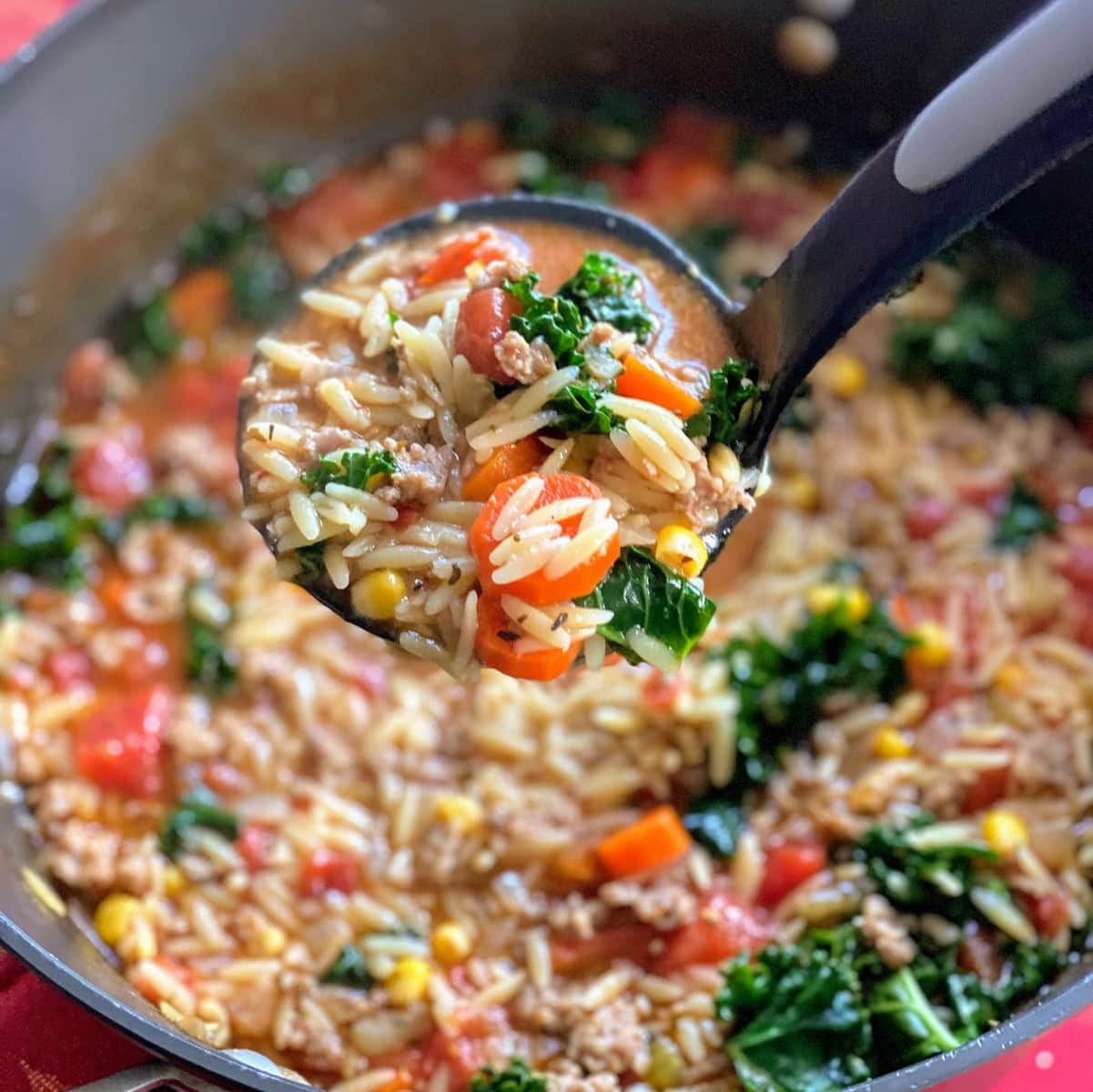 sausage orzo soup with kale in pot
