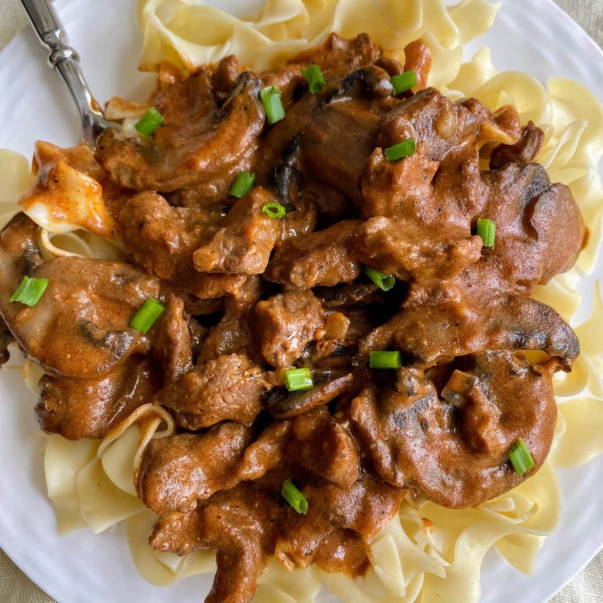 beef over pasta with mushrooms and veggies