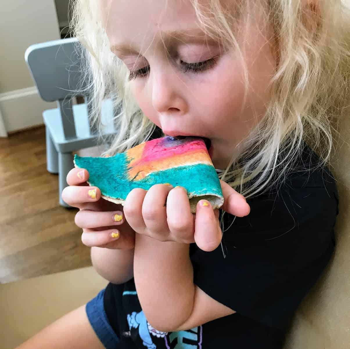 child eating colored tortilla