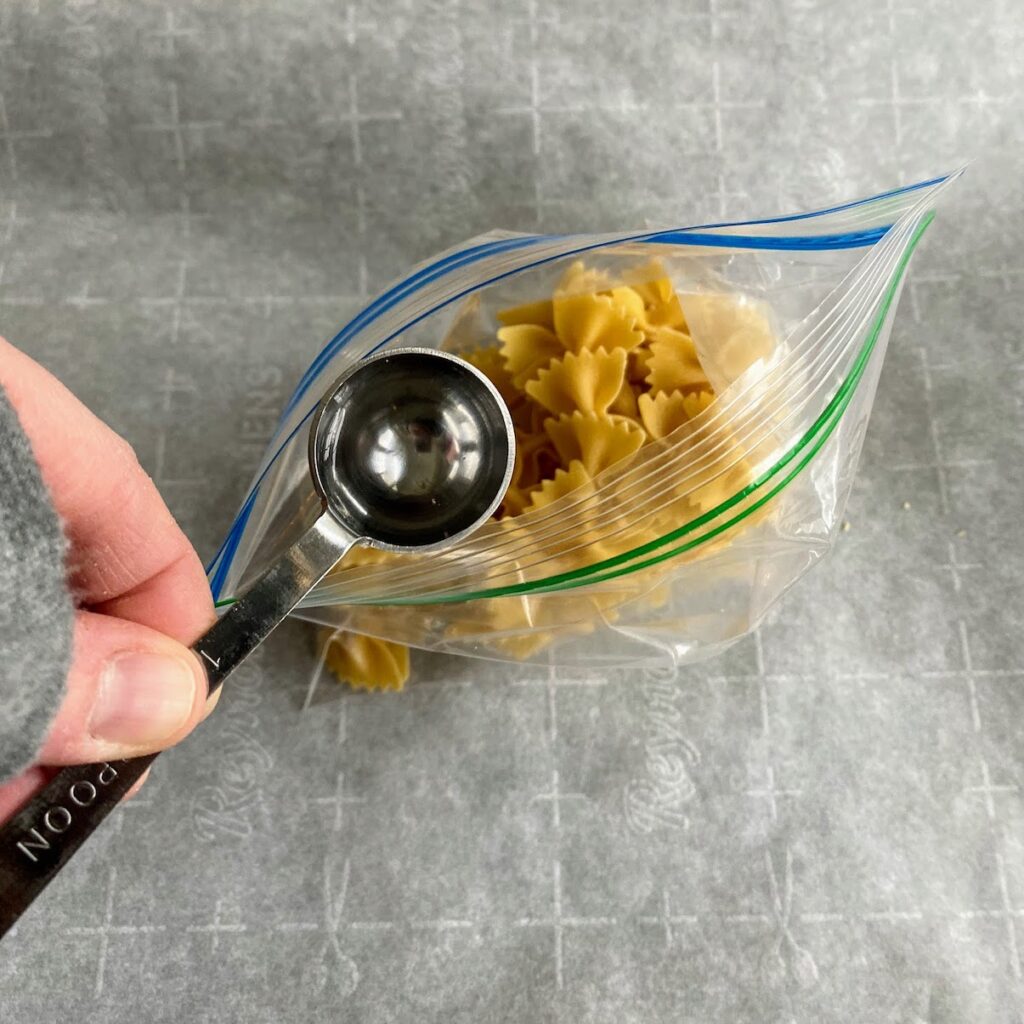 adding vinegar to bag of pasta