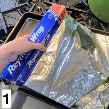 Hand spreading foil on a tray.