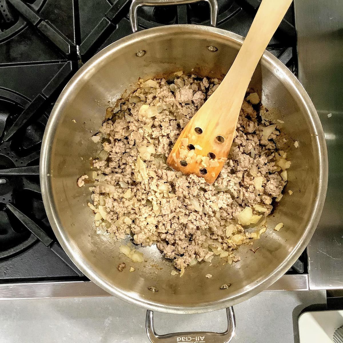 stirring ground turkey in pot