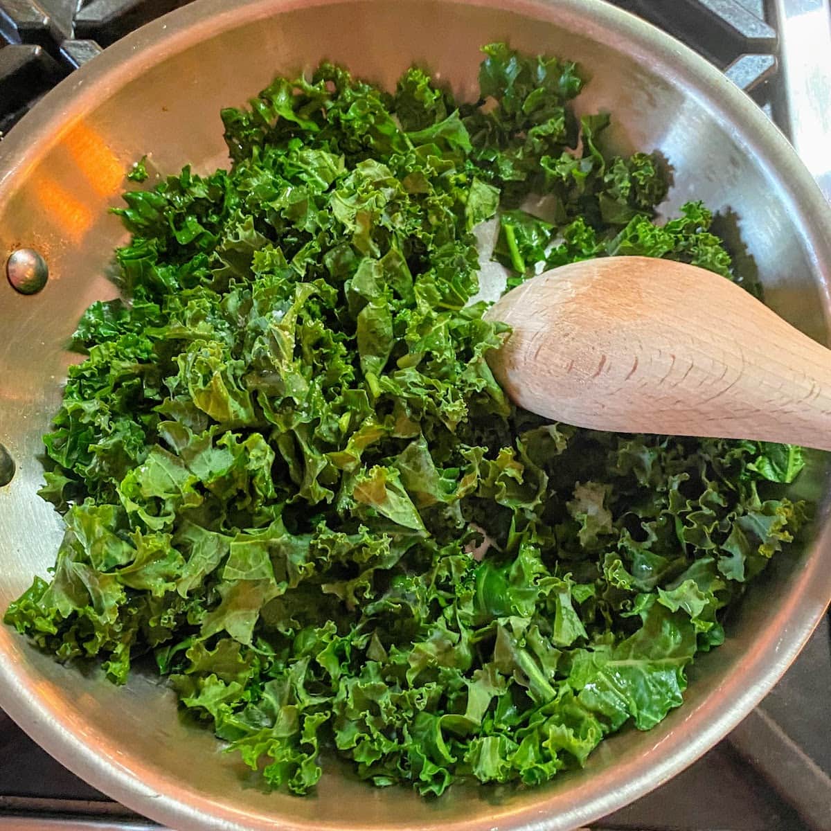 chopped kale cooking in pan