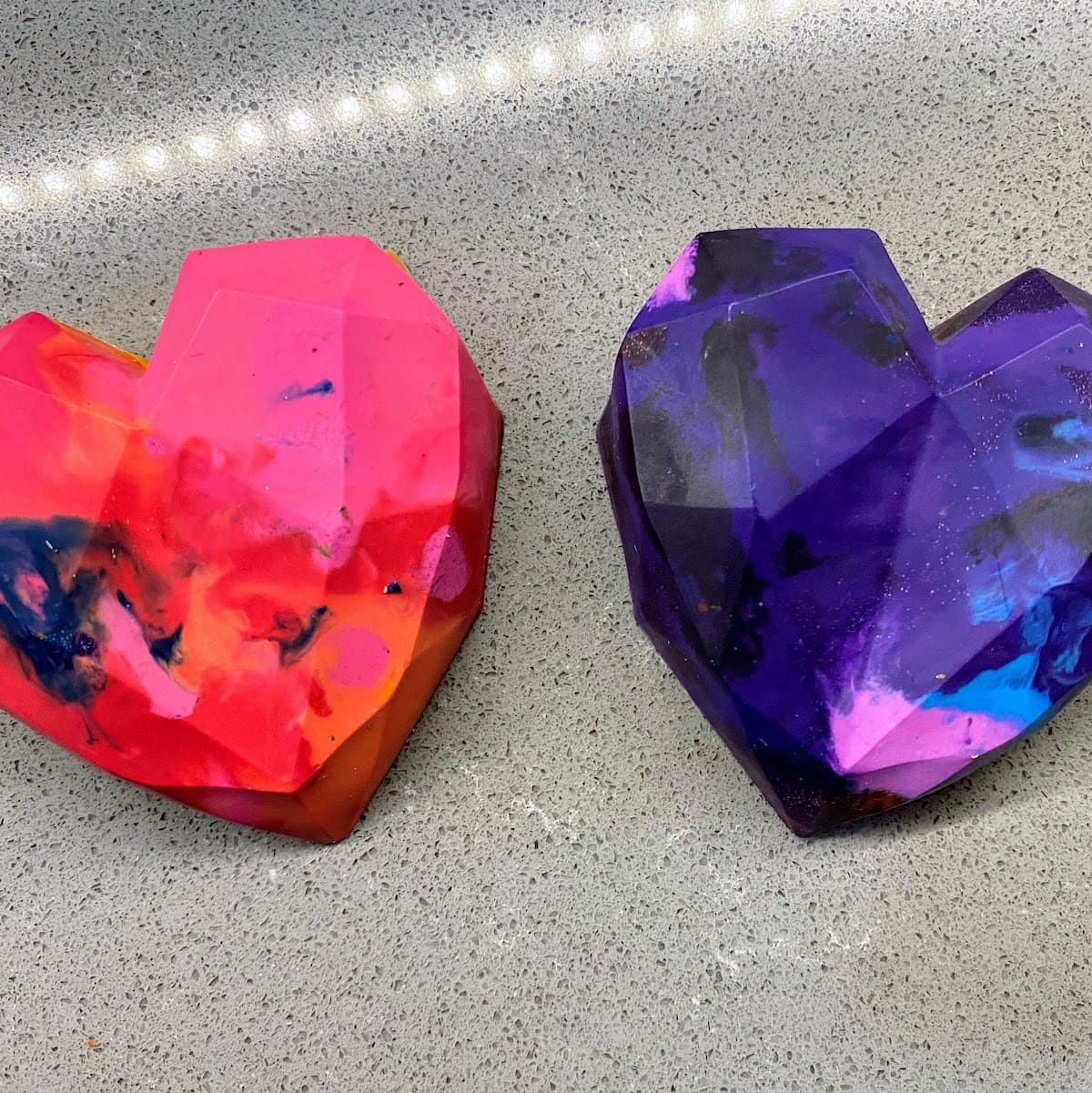 two pink and purple heart shaped crayons