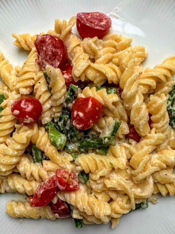 fusilli pasta mixed with asparagus and baby tomatoes