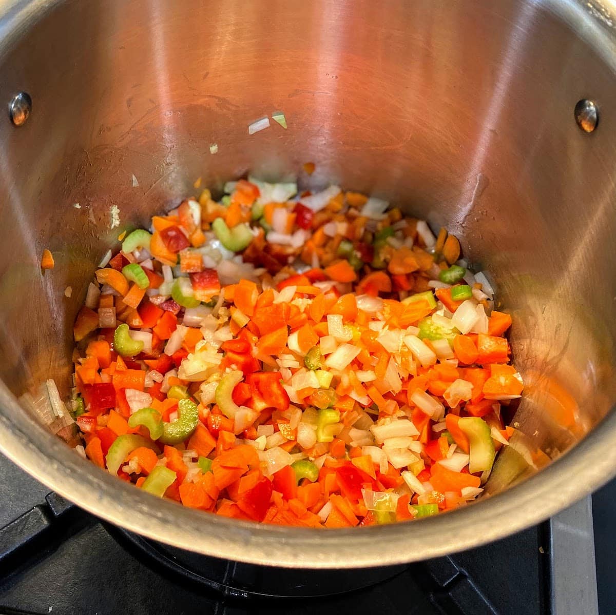 chopped veggies cooking in large pot