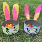 two Easter tins with jelly beans on grass
