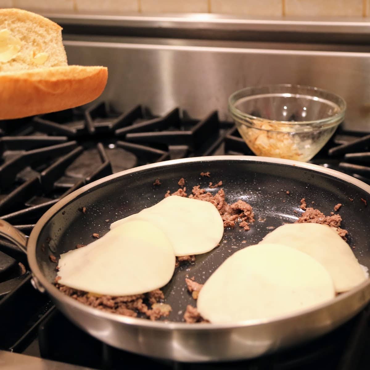 cheese melting on meat in pan
