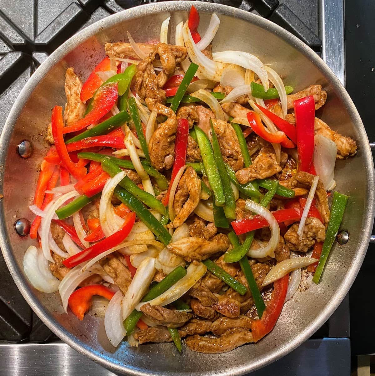 fajita chicken, pepper and onion in pan