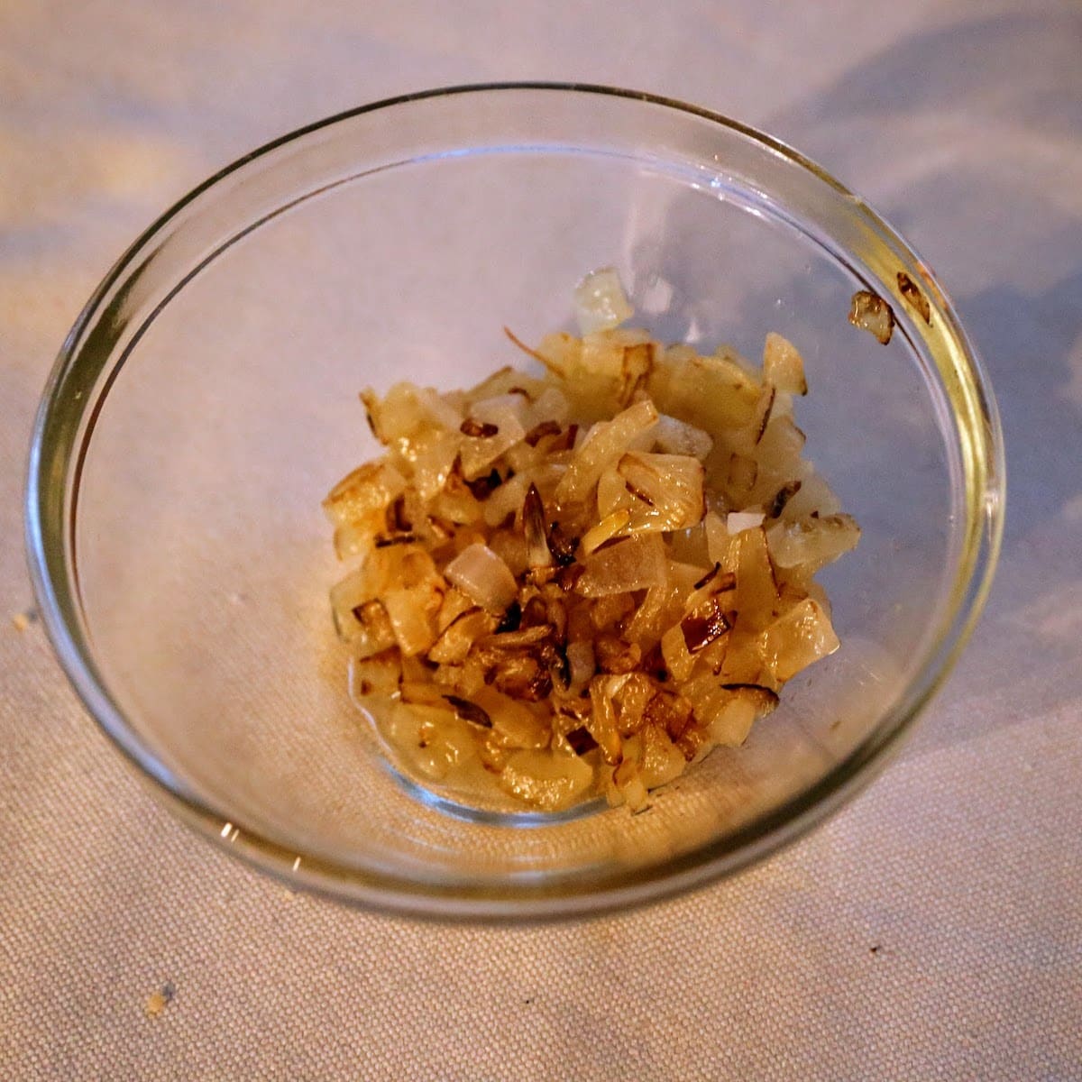 cooked onions in a glass bowl