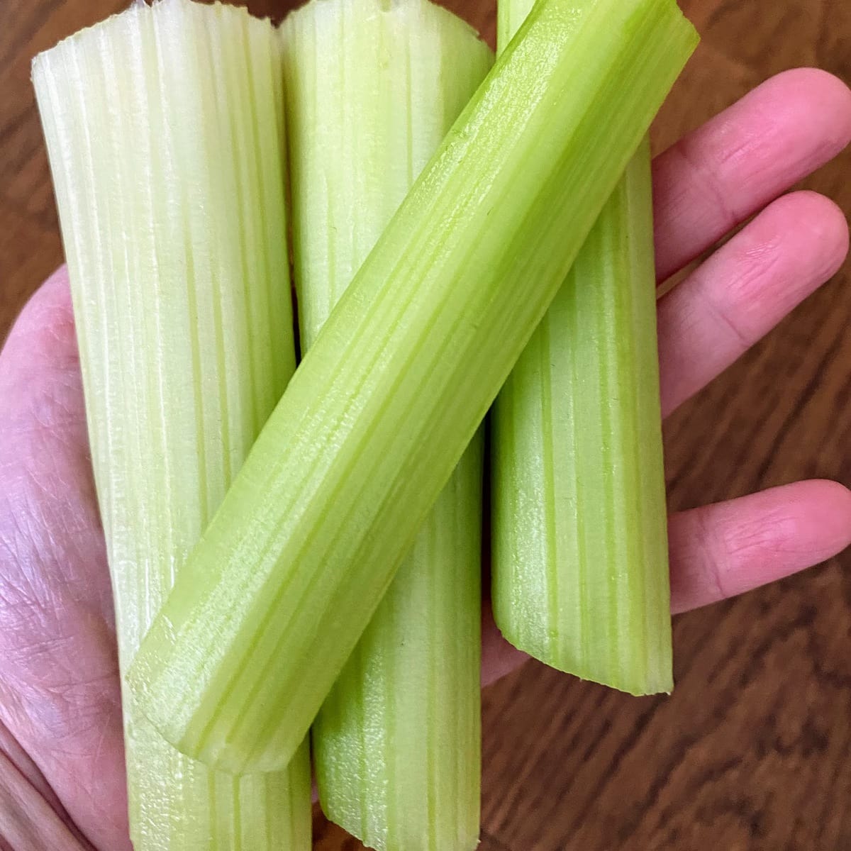 hand holding cut celery sticks