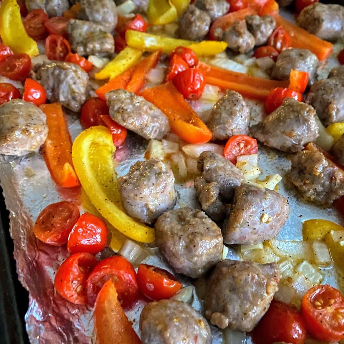 peppers, sausage and tomatoes on pan