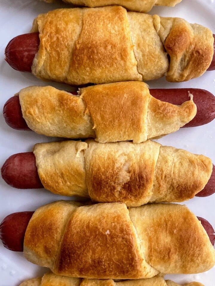 hot dogs in crescent rolls on plate