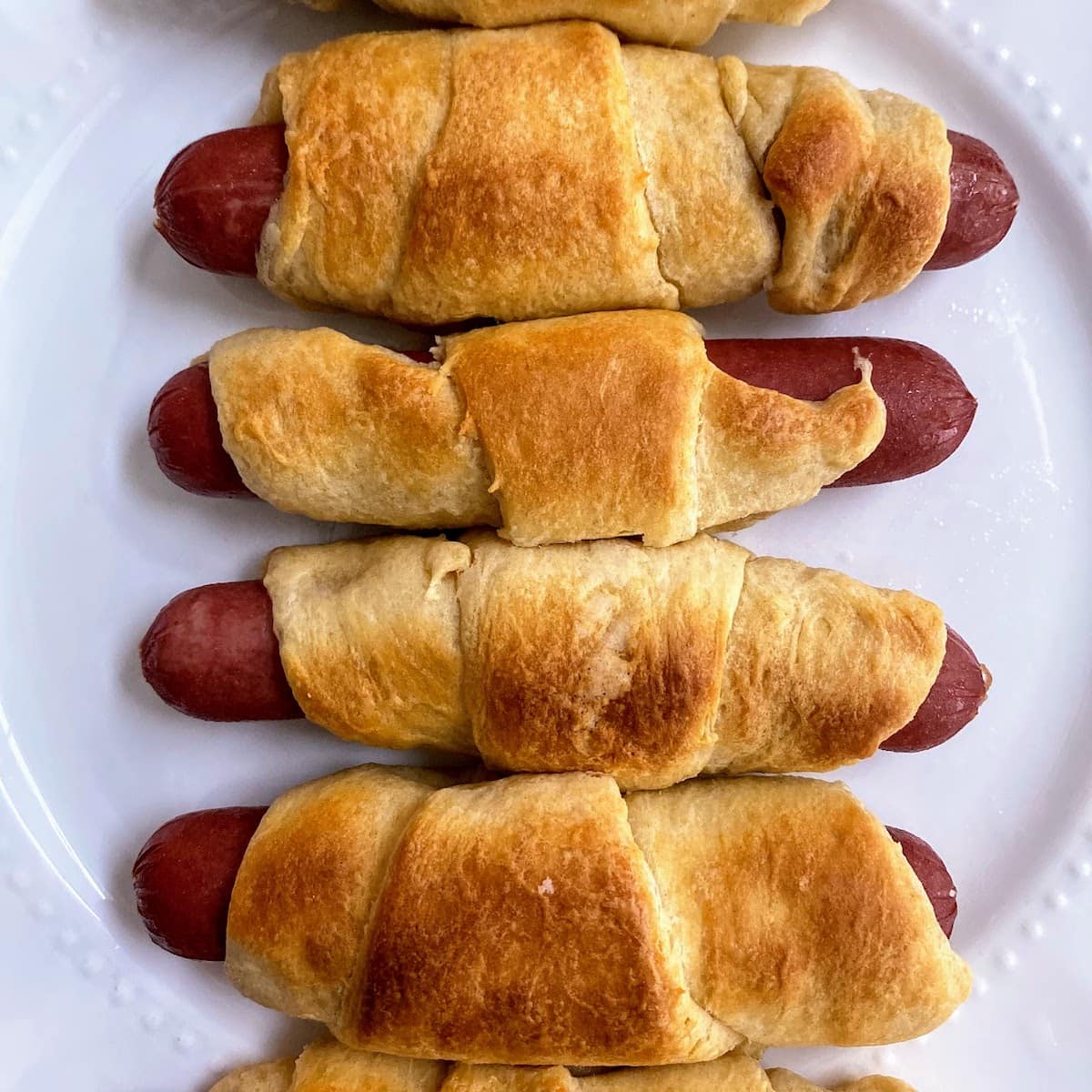 hoot dogs in crescent rolls on plate