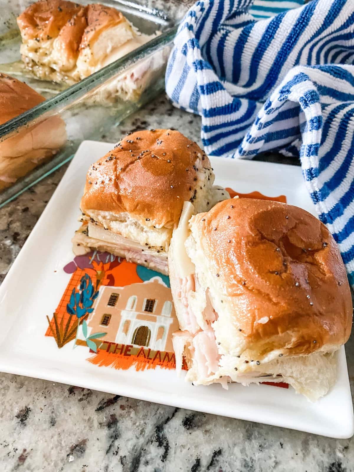 swiss and ham sliders on a plate
