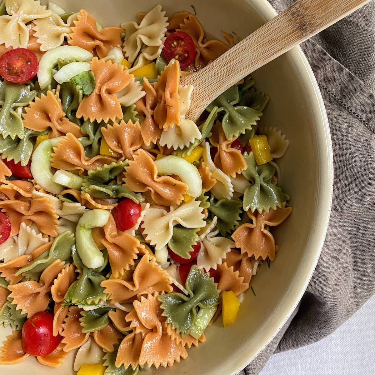 bow tie pasta salad with wooden spoon