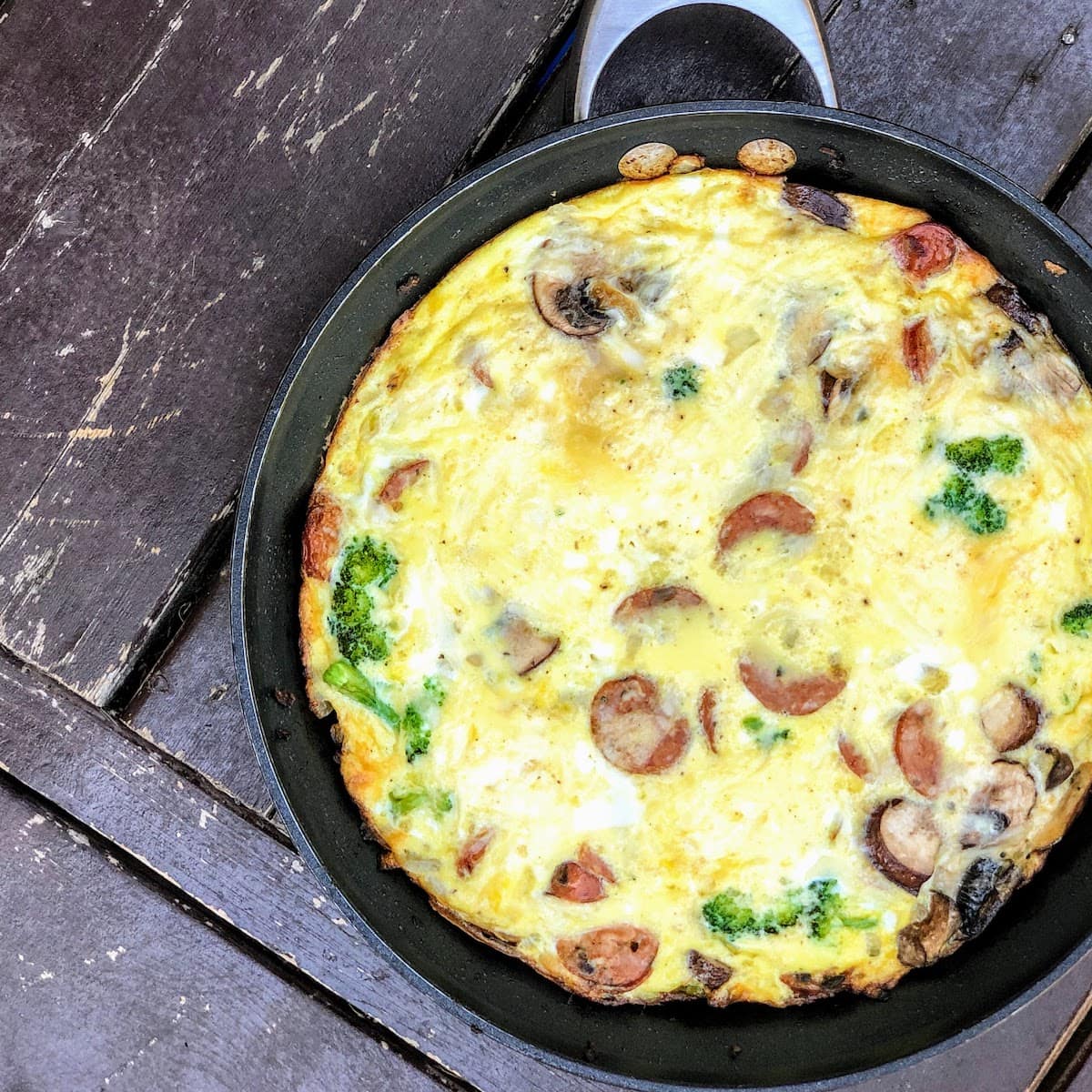 baked frittata in pan with sausage, mushrooms and broccoli