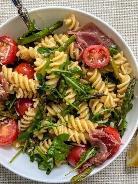asparagus pasta salad in white bowl