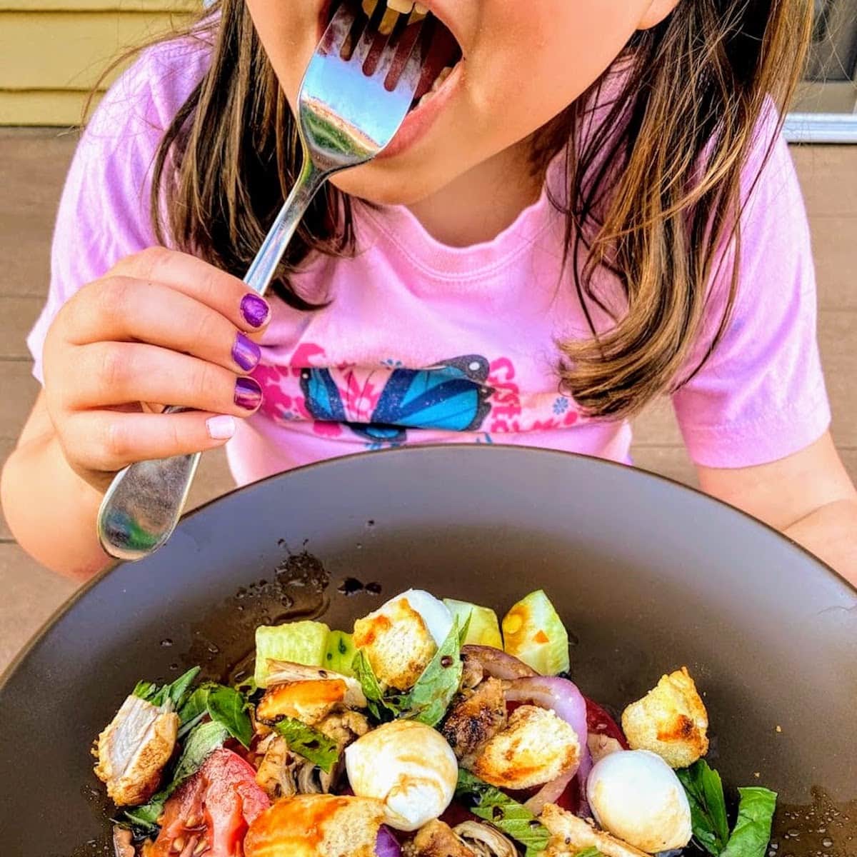 child eating salad
