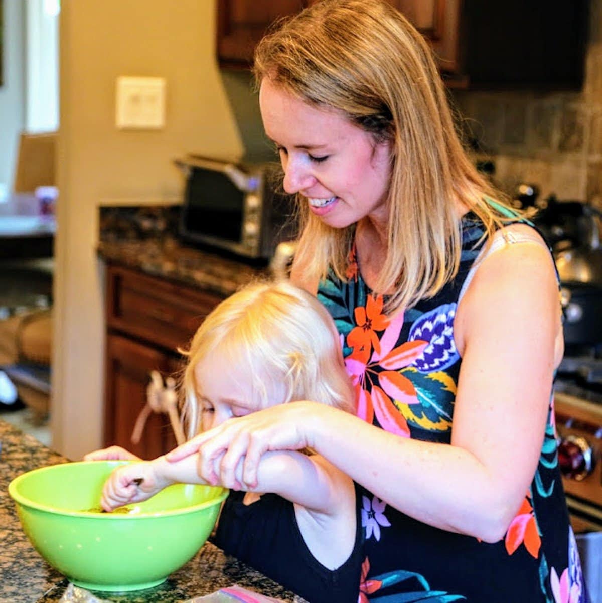 mother and child stirring a bowl of ingredients