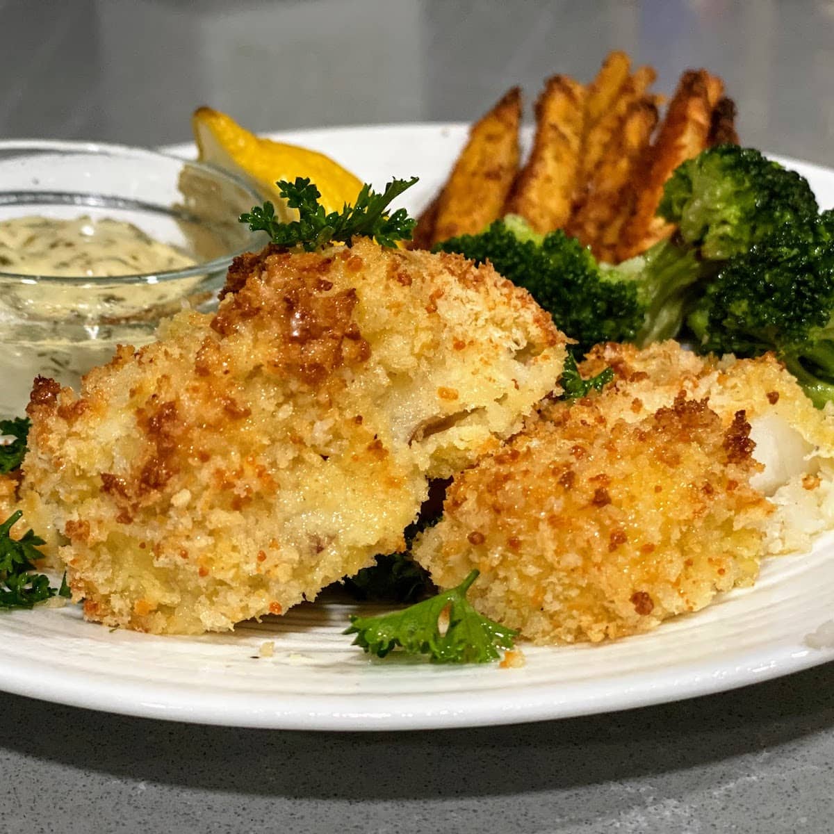 baked cod on plate with broccoli 