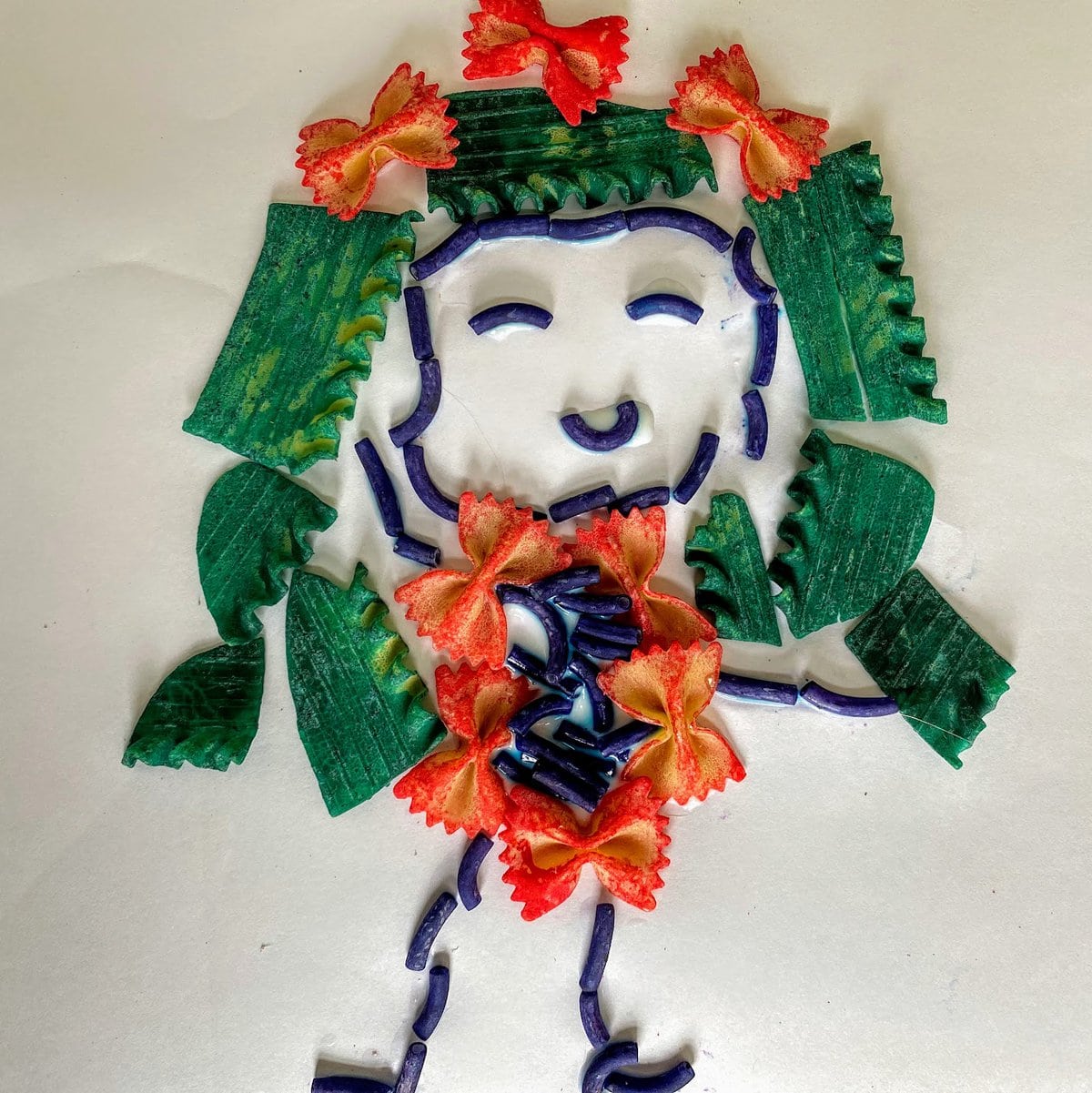 girl made from dyed pasta 