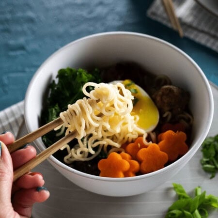 ramen soup with turkey and veggies in white bowl