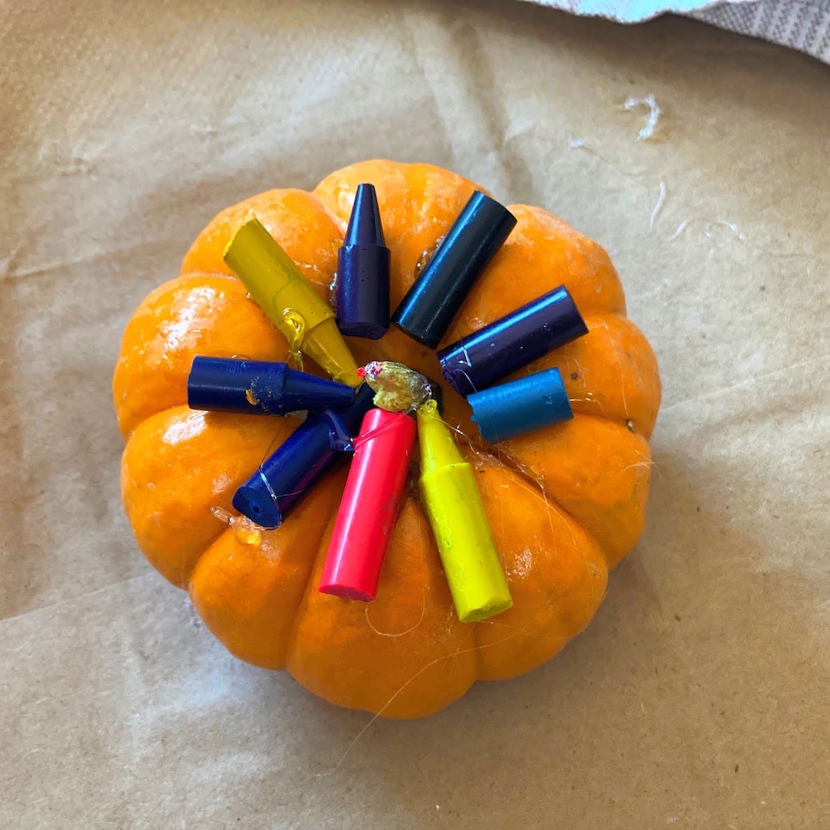 pumpkin with crayons glued to top
