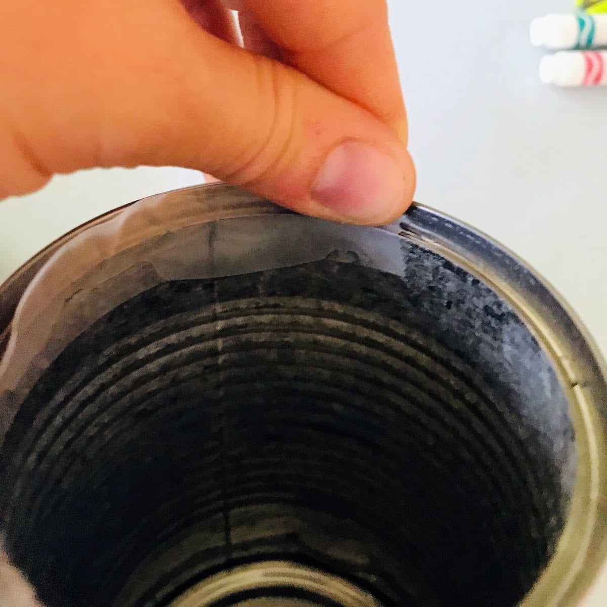 adding tape to the inner rim of a can