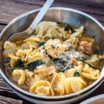 tortellini sausage soup in bowl with spoon