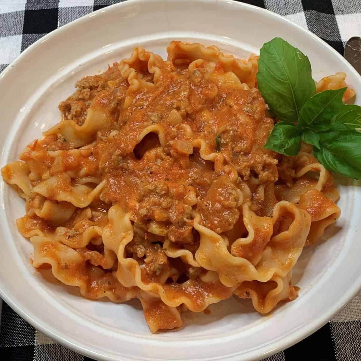 mafalda pasta in red sauce  non white plate 