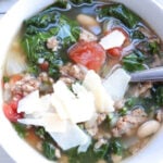 tuscan kale soup topped with parmesan in bowl