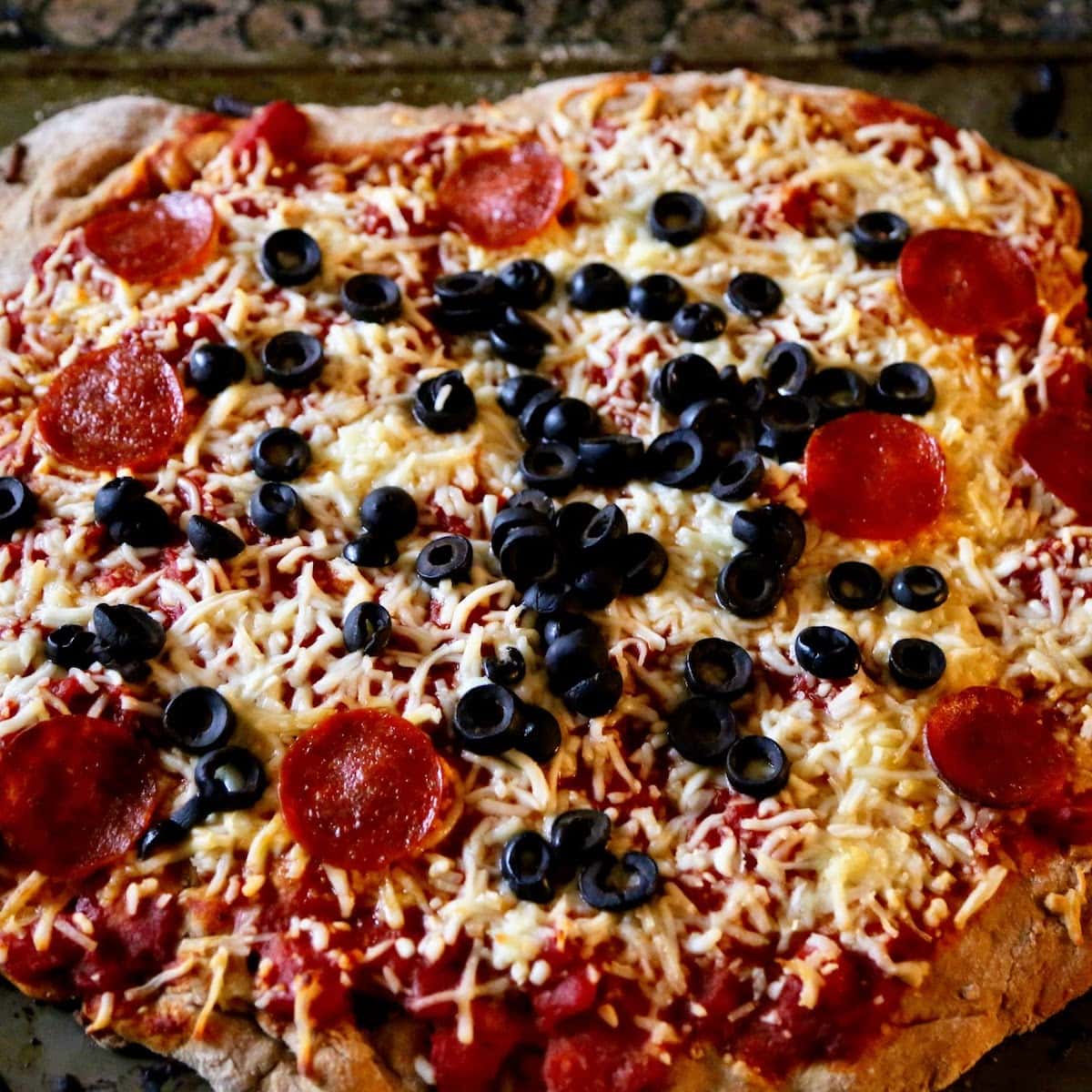 pepperoni pizza with olives close up 