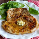 two ports chops with garlic butter on plate