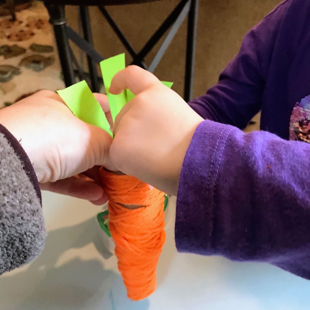 child securing stem to carrot