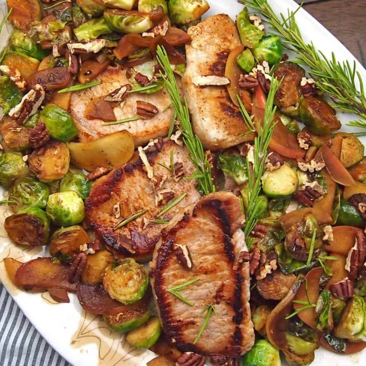 side bring pork chops with veggies on plate